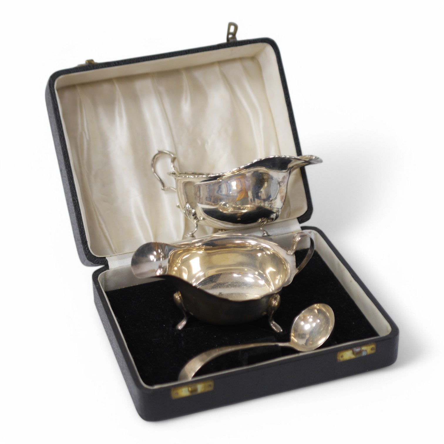 A cased Elizabeth II silver sauce boat and spoon, by Viners Ltd, Sheffield, 1952/5 and one other silver sauce boat. Condition - poor to fair